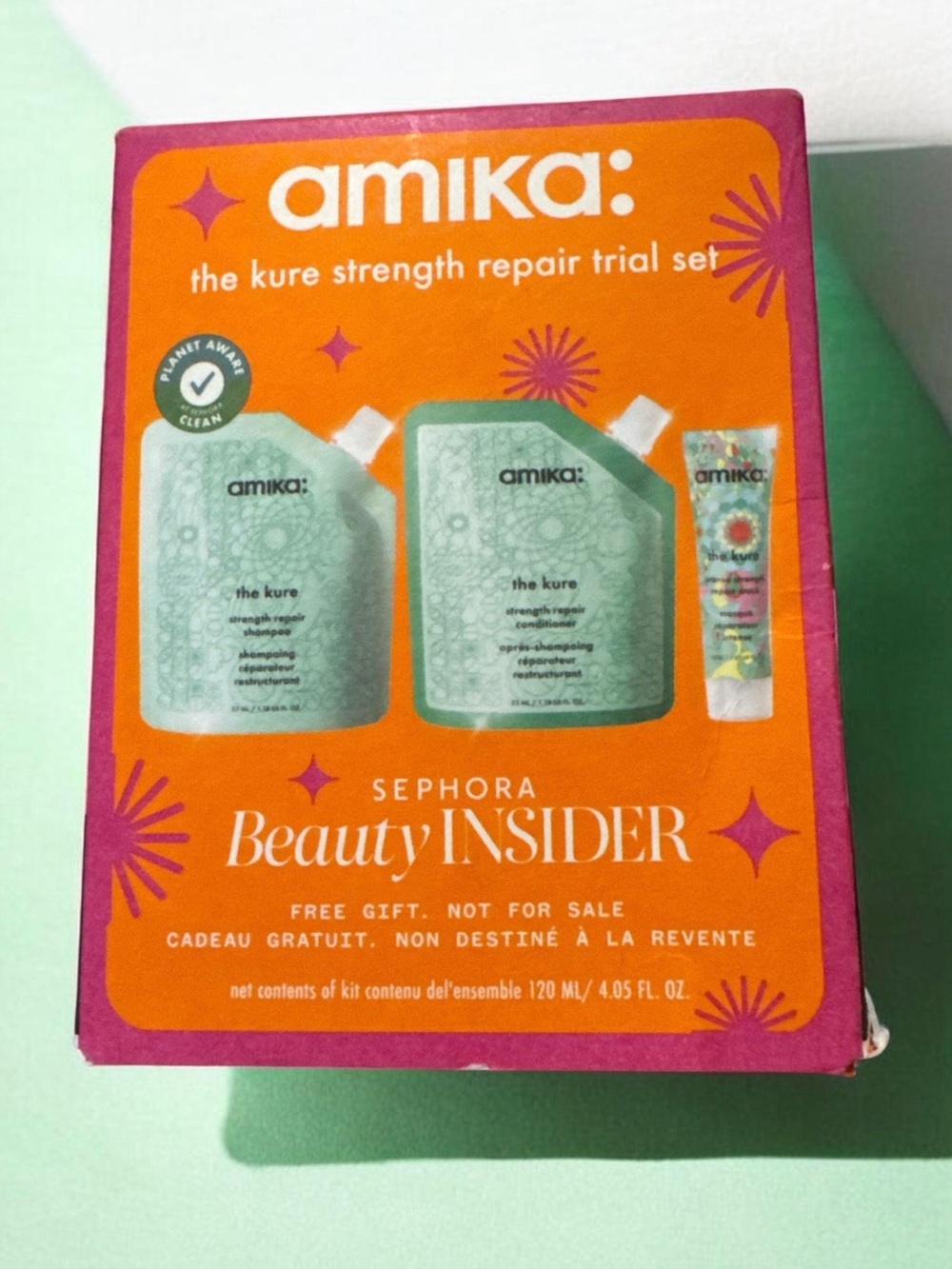 amika orange gift box with teal pouches and pink trim